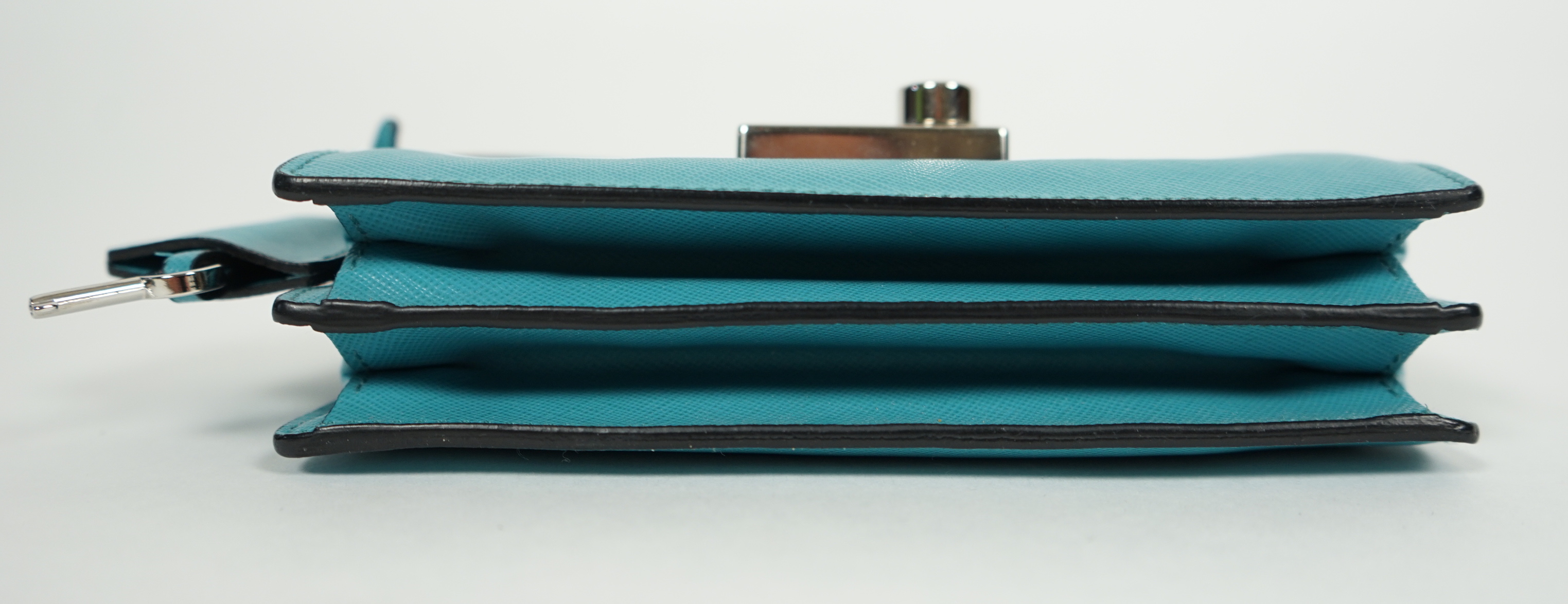 A Prada Saffiano Lux Mini Sound bag in Turchese, width 16cm, height 10cm, depth 4cm, overall height to handle 20cm